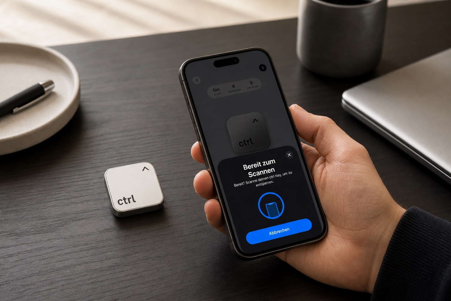 A hand scanning the ctrl key with an iPhone on a dark desk