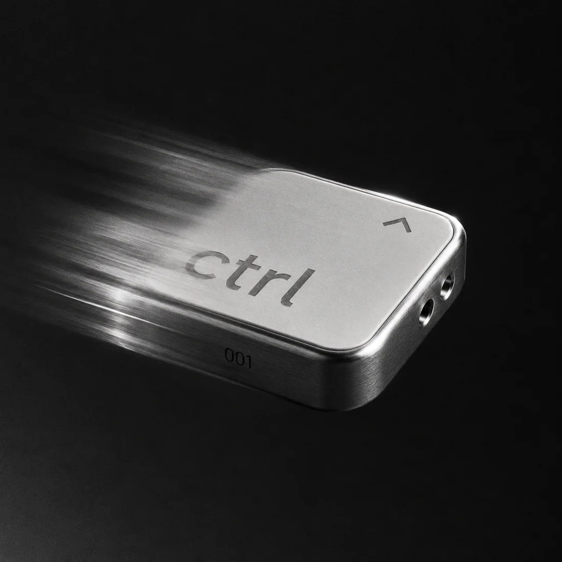 The ctrl key shooting through the dark, a trail of light behind it